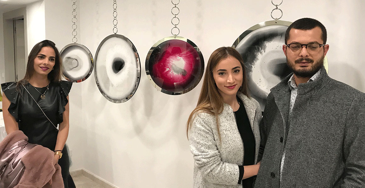Marios Koumi and his loverly sisters posing in front of Stratified Jewels fo the Choices Series Empowerment and Compassion displayed at private view.